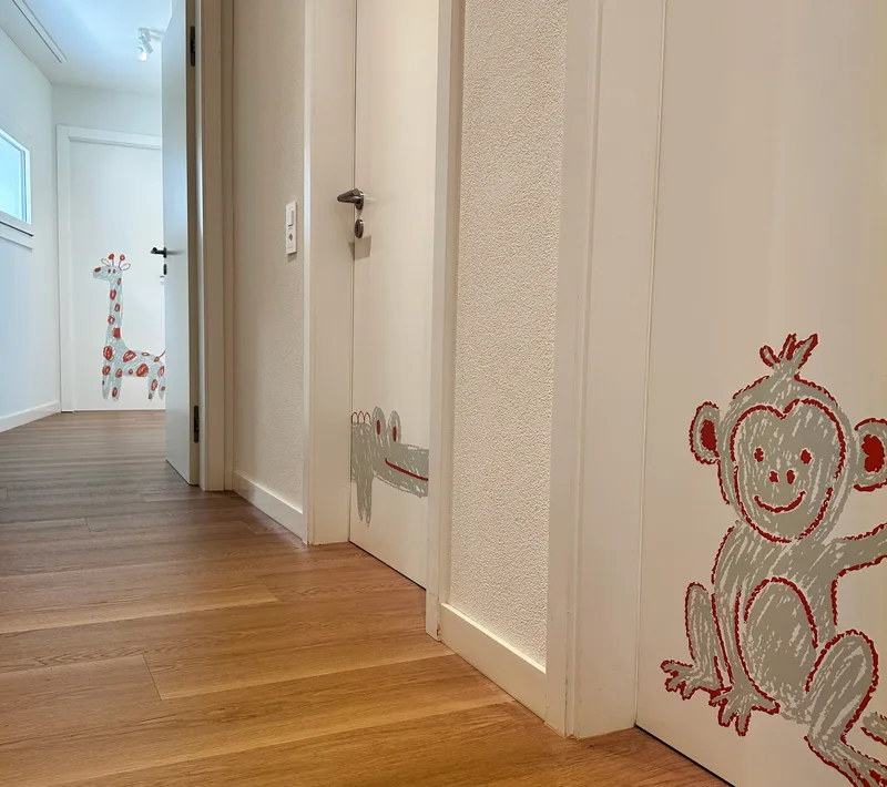 Corridoio della pediatria con disegni di animali sulle porte.